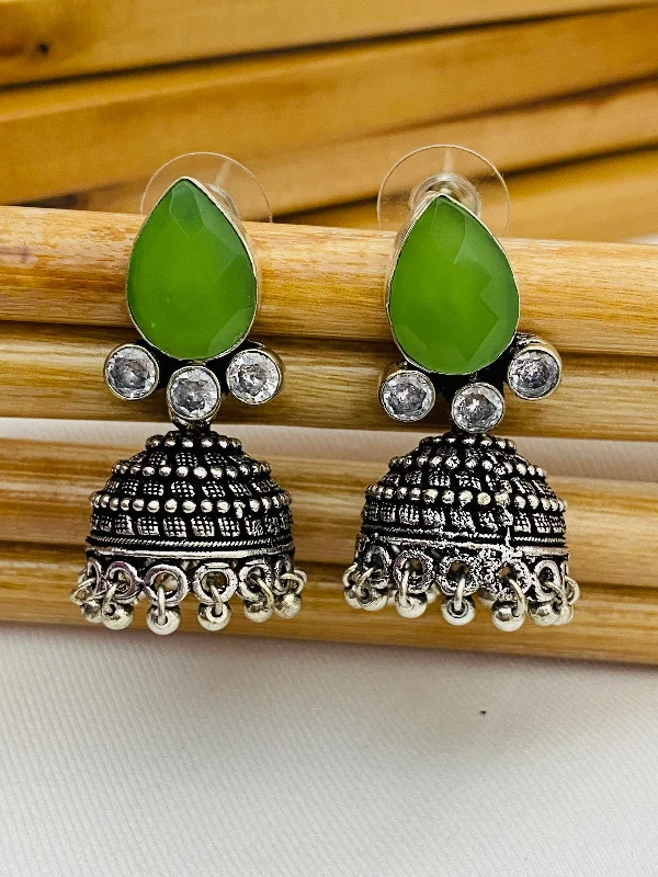 Bold Gemstone Earrings-Lovely Green AD Stone Beaded Silver Toned Designer Jhumka Earrings With Black Pearl Drops